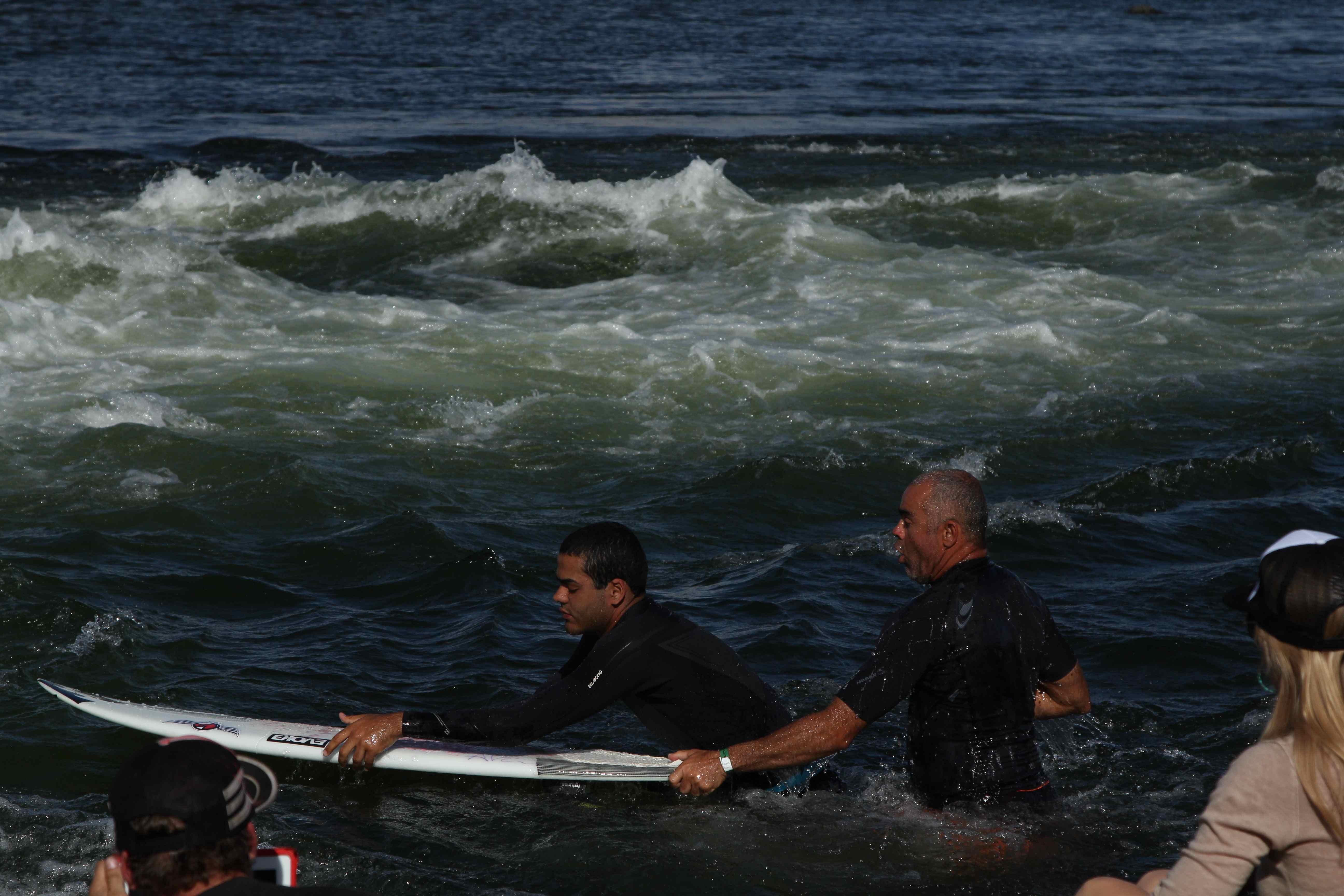 Derek prepares to surf with the help of his dad as KWP founder Kristina Pickard watches on